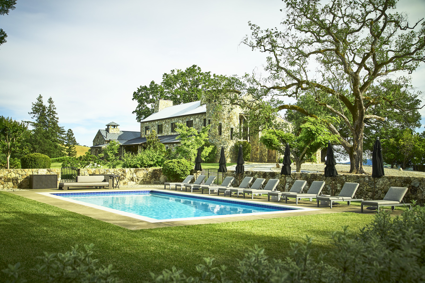 The residence stands behind a pristine swimming pool