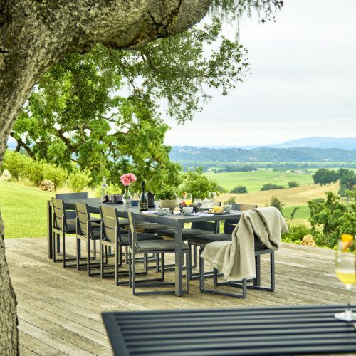 A patio table set for al fresco brunch with sweeping valley views beyond