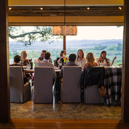 A group of friends enjoys dinner with sweeping views outside the dining room